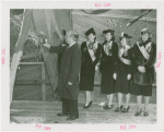 New England Participation - Man christening S.S. Yankee with champagne while beauty queens watch