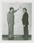 New England Participation - Hannes Schneider showing man wall map