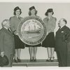 New England Participation - Harvey Gibson and man looking at giant seal of New Hampshire held by Fair guides