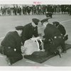 New York City - Police Dept. - Policeman demonstrating giving first aid to victim
