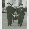 New York City - Police Dept. - Policeman demonstrating removal of victim from accident scene