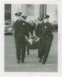 New York City - Police Dept. - Policeman demonstrating removal of victim from accident scene