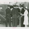 New York City - Police Dept. - Policeman demonstrating moving victim into ambulance