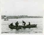 New York City - Police Dept. - Policemen in boats pulling man out of water