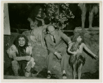 New York Zoological Society - Man sitting with hominids in exhibit