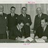 Nicaragua Participation - Noel Ernesto Pallais (Consul General) signs contract, Grover Whalen and group look on