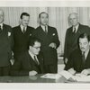 Nicaragua Participation - Grover Whalen signs contract, Noel Ernesto Pallais (Consul General) and group look on