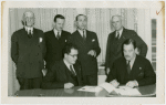 Nicaragua Participation - Grover Whalen signs contract, Noel Ernesto Pallais (Consul General) and group look on