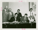 Nicaragua Participation - Noel Ernesto Pallais (Consul General) and Grover Whalen sign contract as group looks on