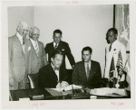 Nicaragua Participation - Noel Ernesto Pallais (Consul General) and Grover Whalen sign contract as group looks on