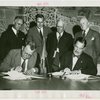 Norway Participation - Frederik Odfjell (Commissioner General) and Grover Whalen signing contracts while group looks on
