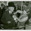 Opening Day - 1940 Season - Woman pinning ""Hello Folks"" label on John Rockefeller