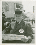 Opening Day - 1940 Season - Man on bench looking at itinerary