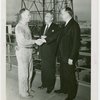 Petroleum - Oil Industry official and derrickman shake hands