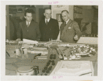 Poland Participation - Antoni Milkowski (Assistant Commissioner), Count Janusz Illinski and Albin Johnson look at model