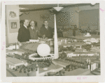 Poland Participation - Antoni Milkowski (Assistant Commissioner), Count Janusz Illinski and Albin Johnson look at model