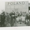 Poland Participation - Official speaking with women in traditional dress before Polish pavilion