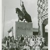 Poland Participation - Witold Wankowicz with women in traditional dress in front of statue