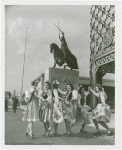 Poland Participation - Women in traditional dress in front of statue of King Jagiello