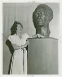 Poland Participation - Hostess in Polish Tea Room and bust of Paderewski