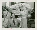 Puerto Rico Participation - Woman putting hat on Blanton Winship (Governor General)