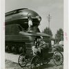 Railroads on Parade - Woman standing on train and man and woman on horseless carriage
