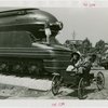 Railroads on Parade - Woman standing on train and man and woman on horseless carriage