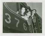 Railroads on Parade - Two men and woman looking out of train window