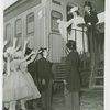 Railroads on Parade - Man and woman in costume standing on train with group waving from below