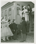 Railroads on Parade - Man and woman in costume standing on train with group waving from below
