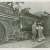 Railroads on Parade - Man and woman in costume walking by train