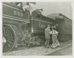 Railroads on Parade - Man and woman in costume walking by train