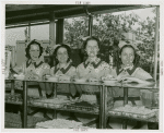 Restaurants - Waitresses at counter with plates of doughnuts