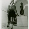 Romania Participation - Woman in traditional dress by statue