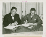 Siam official and Grover Whalen signing contracts