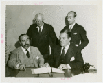 Spanish officials and Grover Whalen signing contract