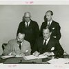 Syrian officials and Grover Whalen signing contract