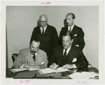 Syrian officials and Grover Whalen signing contract