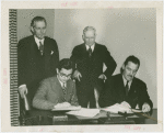 Syrian officials and Grover Whalen signing contract