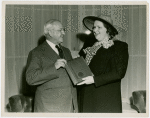 Kate Smith and Harvey Gibson holding plaque