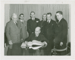 Special Days - Governors' Day - Governor signing book as group looks on