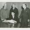 Special Days - Governors' Day - Governor signing book as group looks on