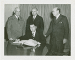 Special Days - Governors' Day - Governor signing book as group looks on