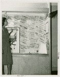 Special Days - Pan-American Day - Woman looking at newspaper exhibit in Inter-America House