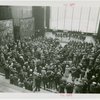 Speeches - Crowd of men and women in assembly hall