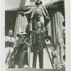 Speeches - Man giving speech in front of statue of George Washington