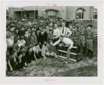 Sports - Man demonstrating hurdle jumping to boys