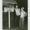 Sports - Two men on roller skates next to sign
