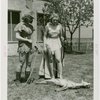 Sports - Archery - Two women in costumes with bows looking at dead deer