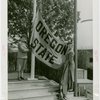 Sports - Banner - Two women raising Oregon State flag